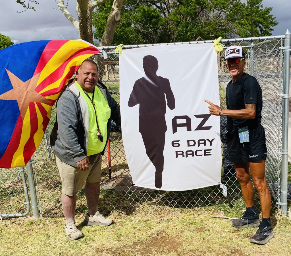 Photo at the Arizona 6 Day Race with the AZ 6 Day Race banner.